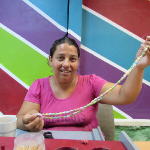 Roma woman creating necklaces