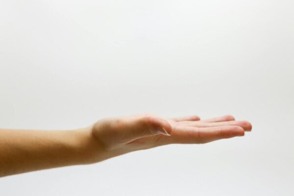 Detailed close-up of an open human hand on a white background, emphasizing gestures and expressions for giving tuesday blog post