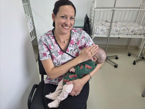 Ramona with a baby in Romania